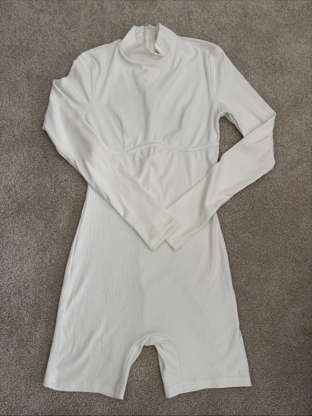 Glamaker Ribbed Long Sleeve Mock Neck Onesie Romper in off white.